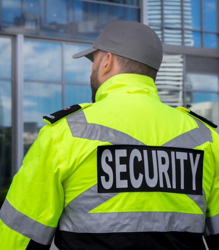 Security guard in uniform patrolling a residential area.